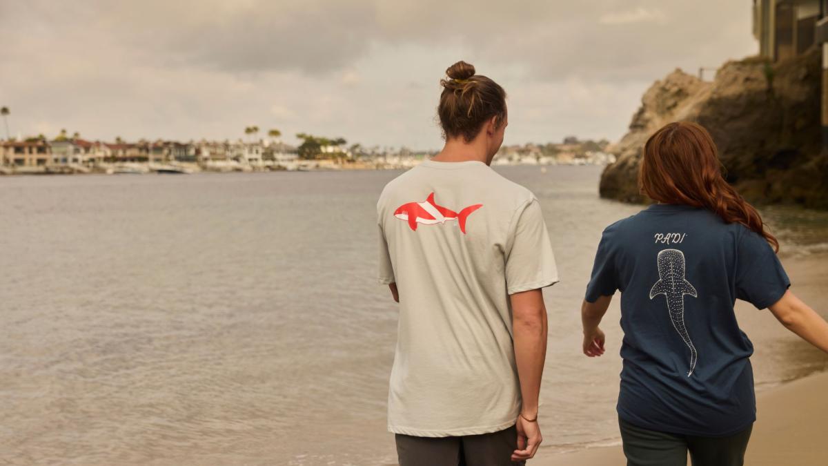 may-gear-hero.jpg a couple of people showing their 幸运飞行艇手机彩票开奖网 whale shark tees